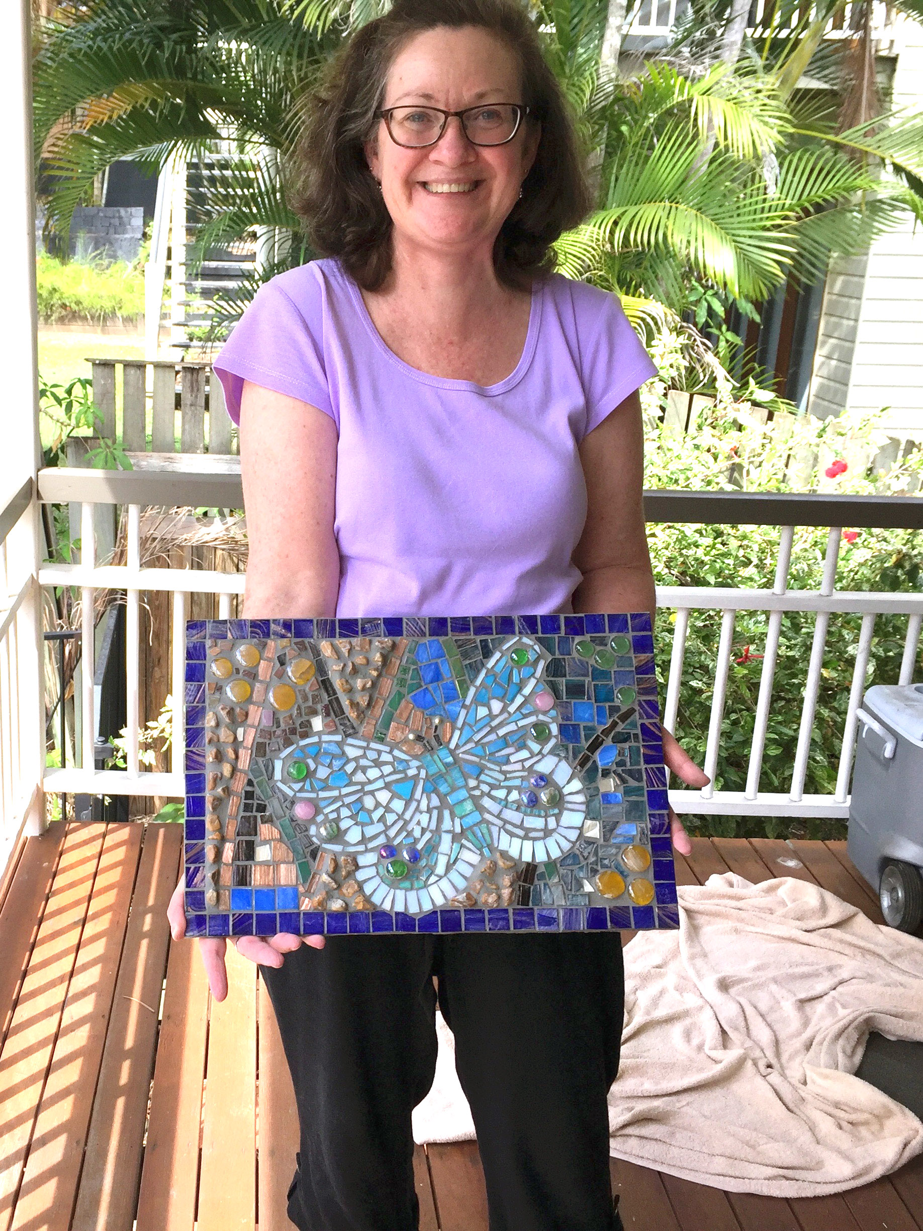 Carol holding Mosaic artwork