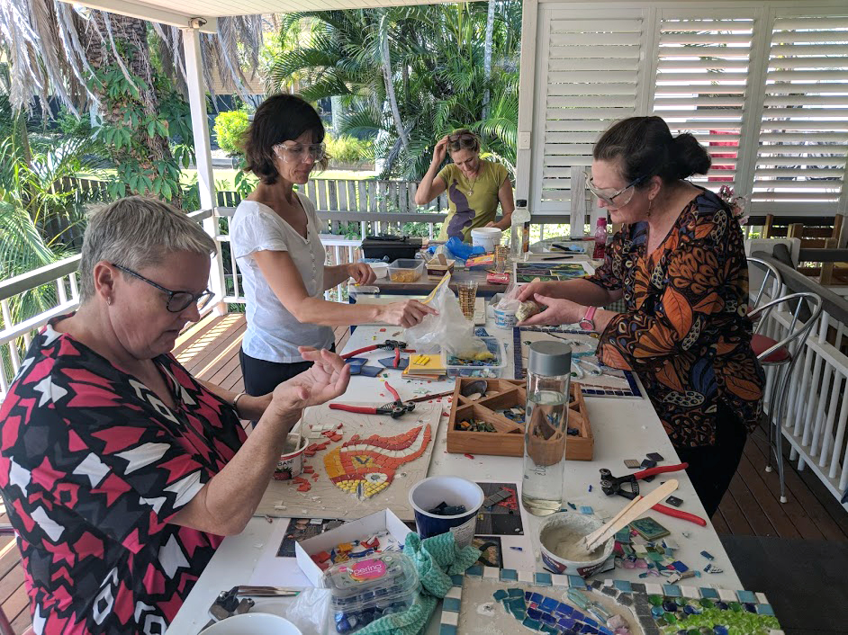 ladies working on mosaic project
